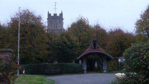A picture of the approach to Kelsale Church showing the tower and lych gate.